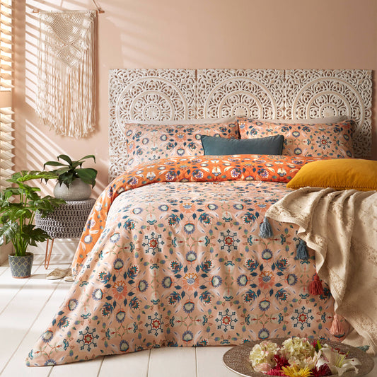 Bedroom with floral folk art, scandi style bedding in orange and pink