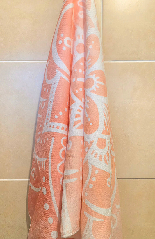 Orange ombre Mandala beach towle on a hook