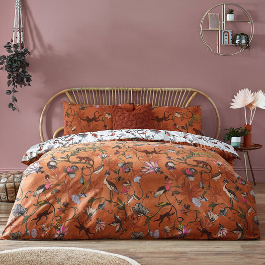 Wildlings jungle duvet set with a vibrant print of monkeys, cheetahs, and tropical birds on a green foliage background
