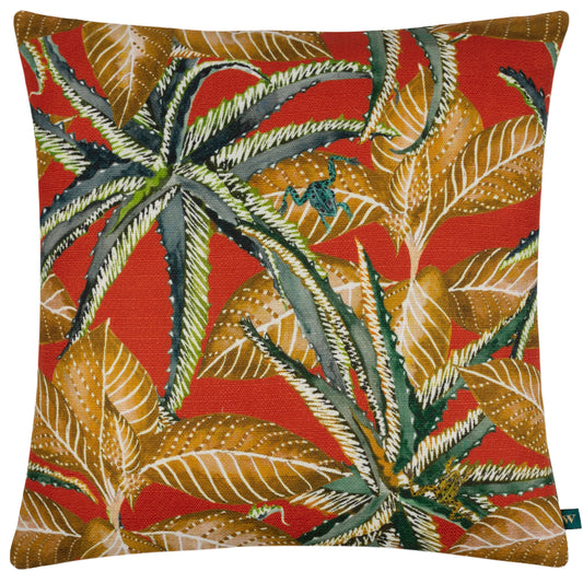 "Jahi tropical cushion with bold green florals, gold leaves, and a hidden frog detail on a vibrant orange background."