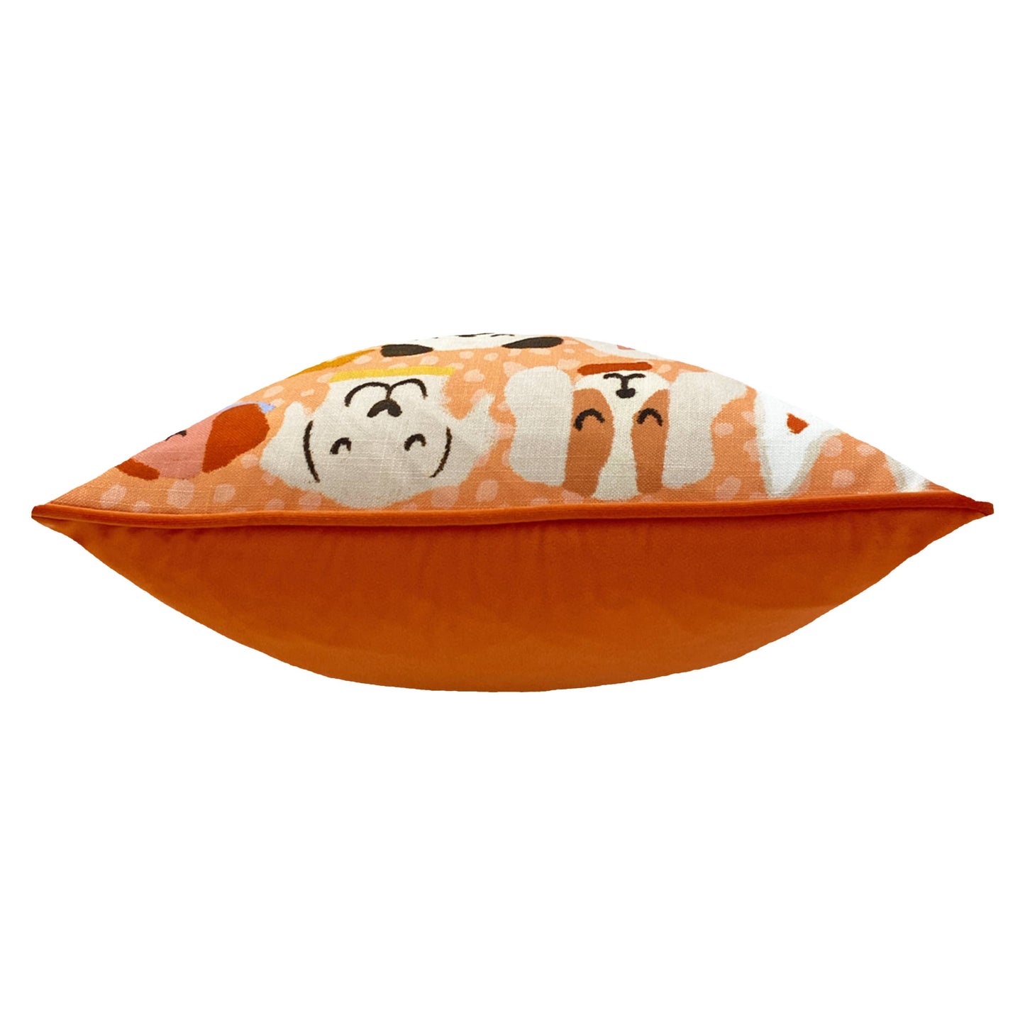 Orange pillow with cartoon dog faces on a white background