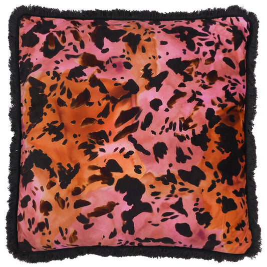 Maximalist animal print cushion with pink and orange background and black fringe trim 