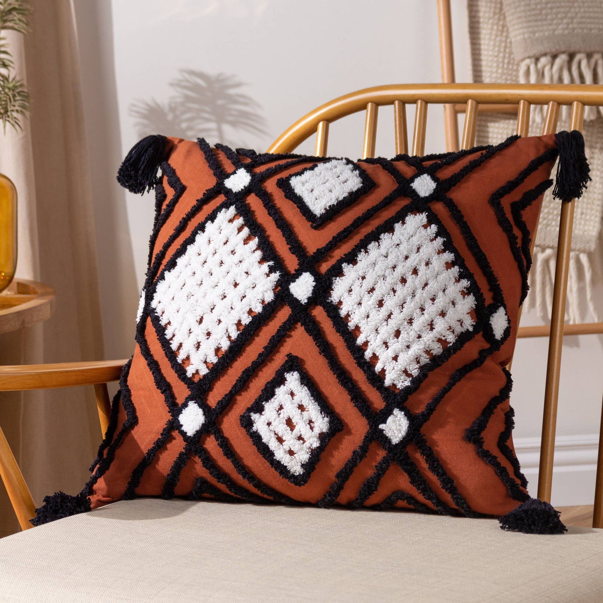 Aquene white diamond tufted cotton cushion with geometric embroidery and chunky corner tassels.