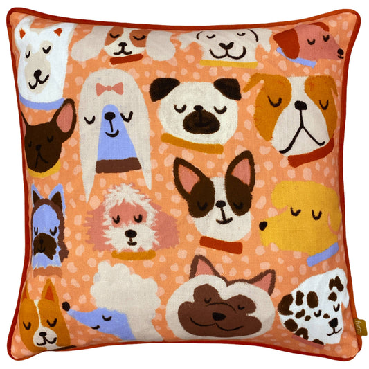 Decorative cushion with cartoon dog faces on an orange background